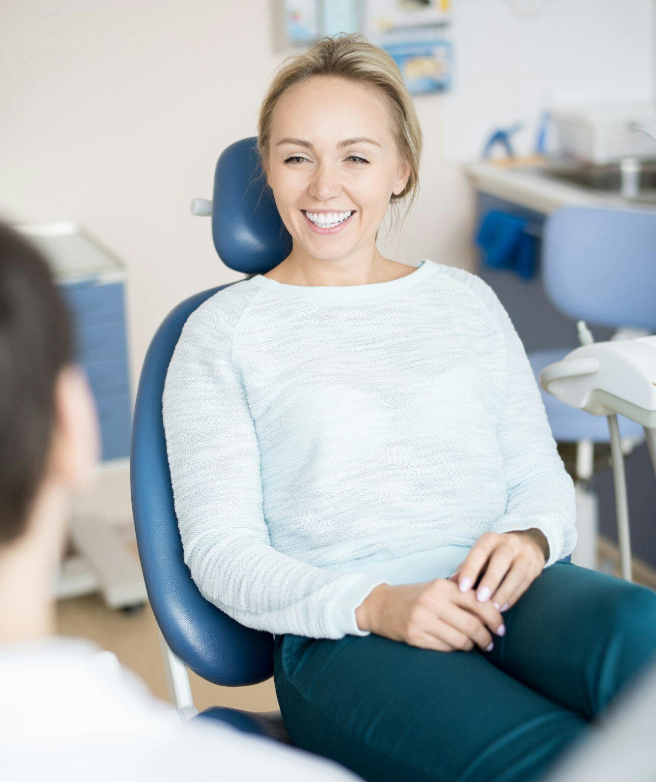 Cheerful woman in chair of dentist